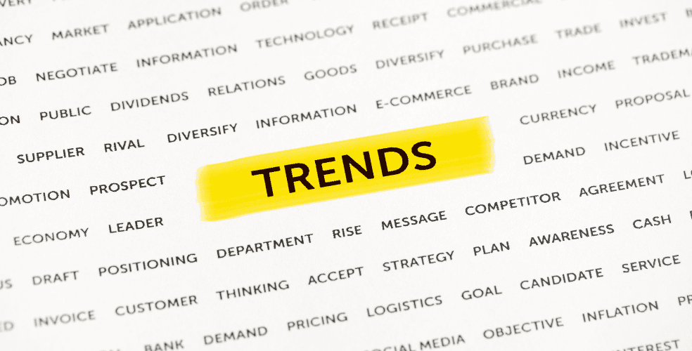 Primo piano su un testo evidenziato con la parola 'TRENDS' circondato da termini legati al business e al marketing su carta, rappresentando i trend emergenti nel web design che i professionisti del settore non dovrebbero trascurare nel 2025.