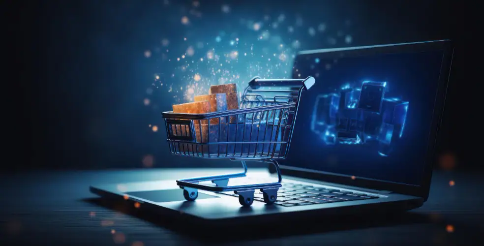 Immagine concettuale di un carrello della spesa digitale posizionato sopra la tastiera di un laptop, con scatole luminose all’interno e particelle di luce che fluttuano nell’aria, simboleggiando l’e-commerce, la digitalizzazione delle vendite e l’innovazione tecnologica nel commercio online.